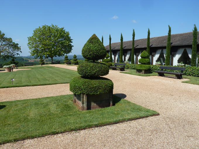 Green sculptures line the visitor centre and give a clue to the topiary garden within the gates.