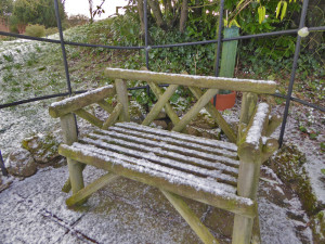 Wooden bench in the snow at Hodsock Priory